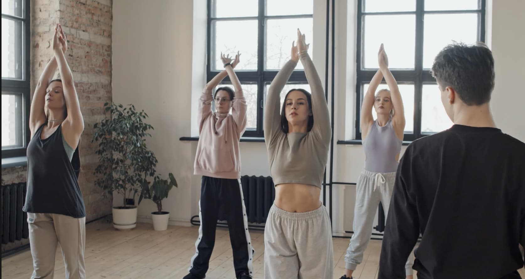 Dancers stretching in a rehearsal studio